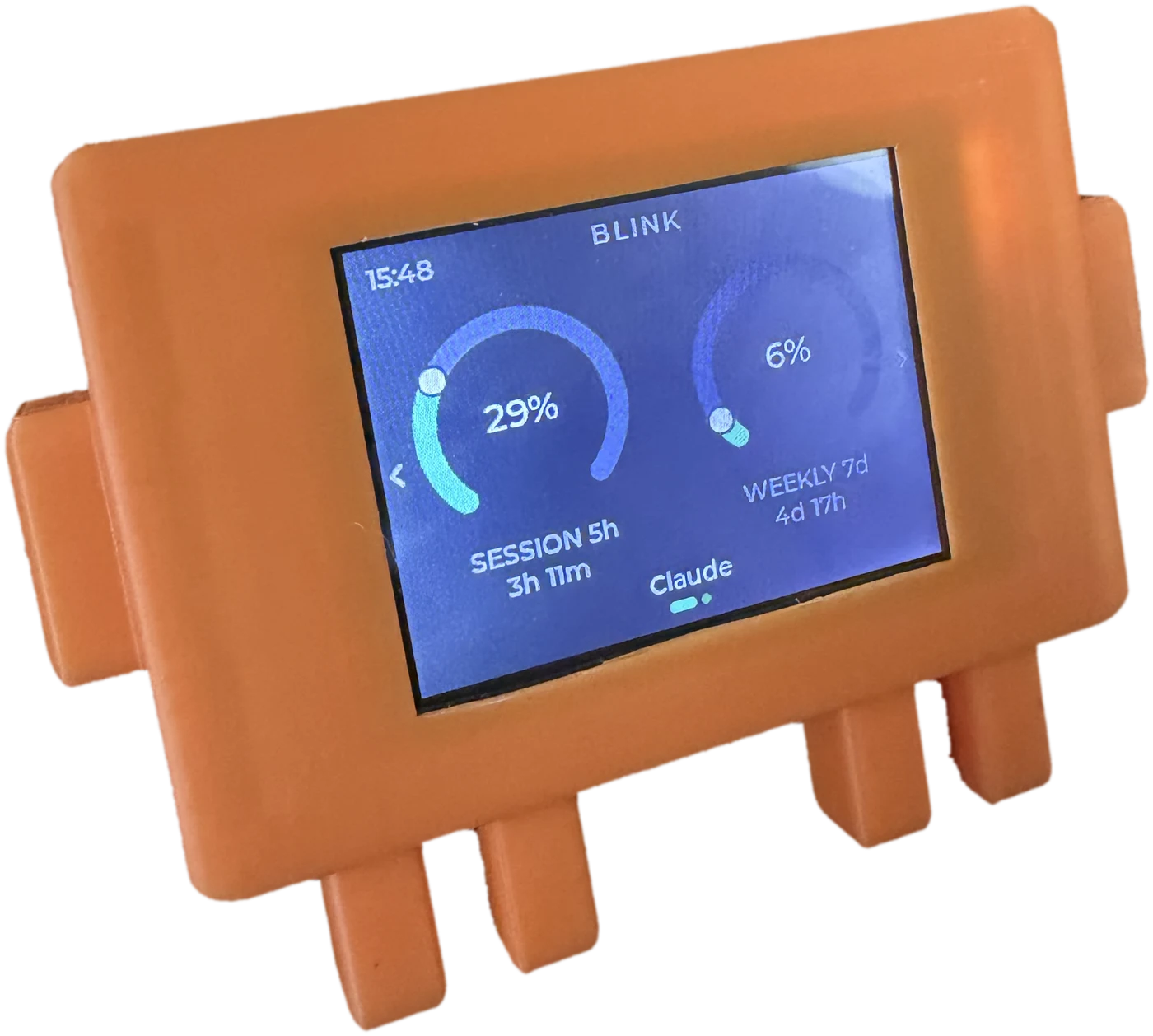The Claude Code logo: an orange case on stubby legs, its screen reading BLINK with a session dial at 29 per cent and a weekly dial at 6 per cent.